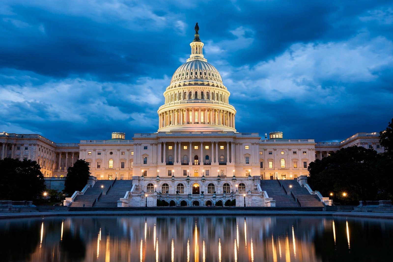 The US Capitol in Washington DC glowing at dusk under a deep blue sky