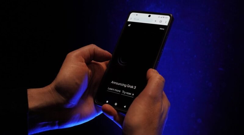 Close-up of hands holding a smartphone displaying 'Announcing Grok 3' on a dark background.